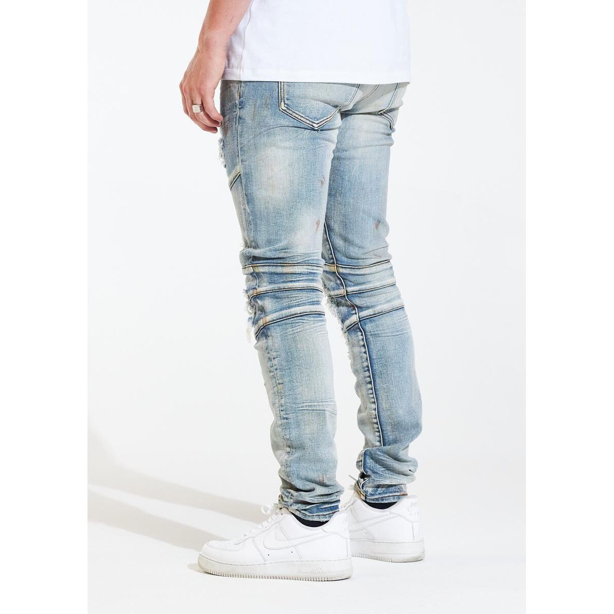 Model wearing Crysp Denim Montana Blue Ripped Biker Jeans, styled with a graphic tee and sneakers