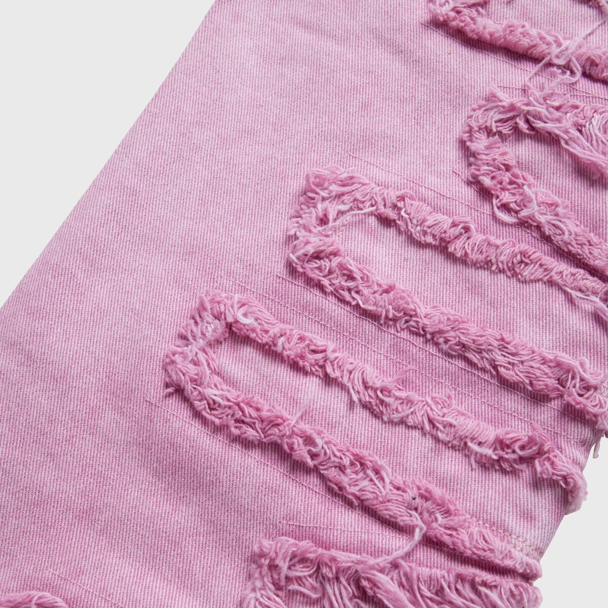 Homme + Femme Twilight Pink Denim Jeans in sunset lighting, showcasing the color and fit