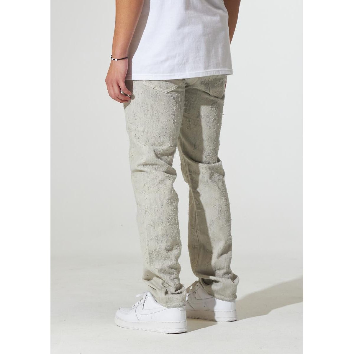 Crysp Denim Arctic Cream Distress Jeans folded to show back pockets and distressing