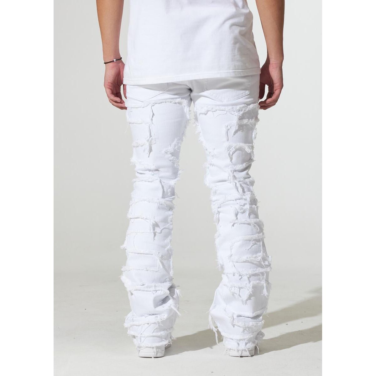 Crysp Denim Arch White Distress Jeans folded and stacked on a shelf