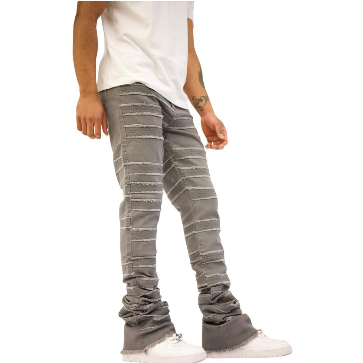 Model wearing Doctrine Kill Joy Stacked Jeans - Gray Wash with a rolled cuff styling