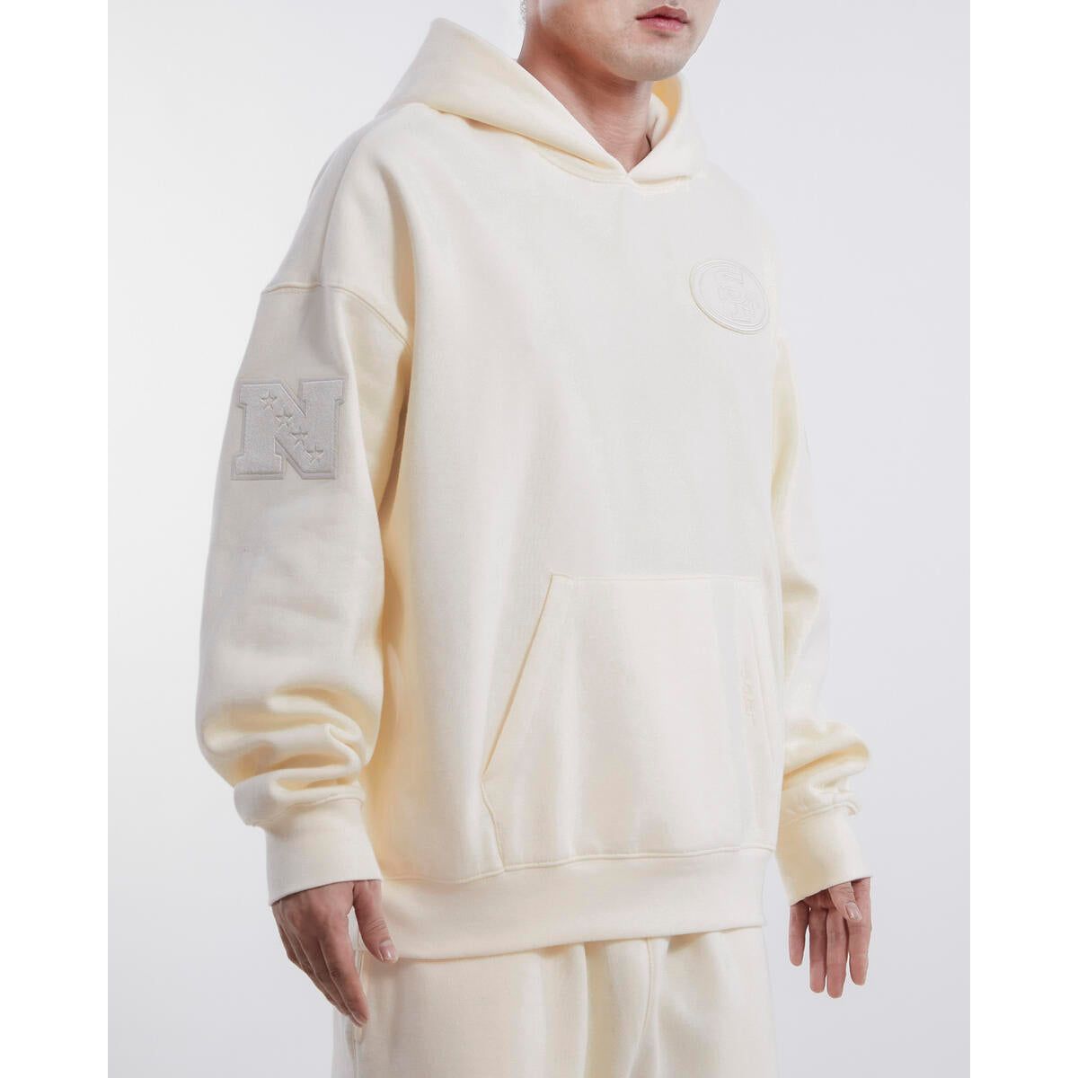 Pro Standard San Francisco 49ers Neutral Drop Shoulder Hoodie in Eggshell color, style number FS4544637-EGG, featuring team logo and comfortable fit