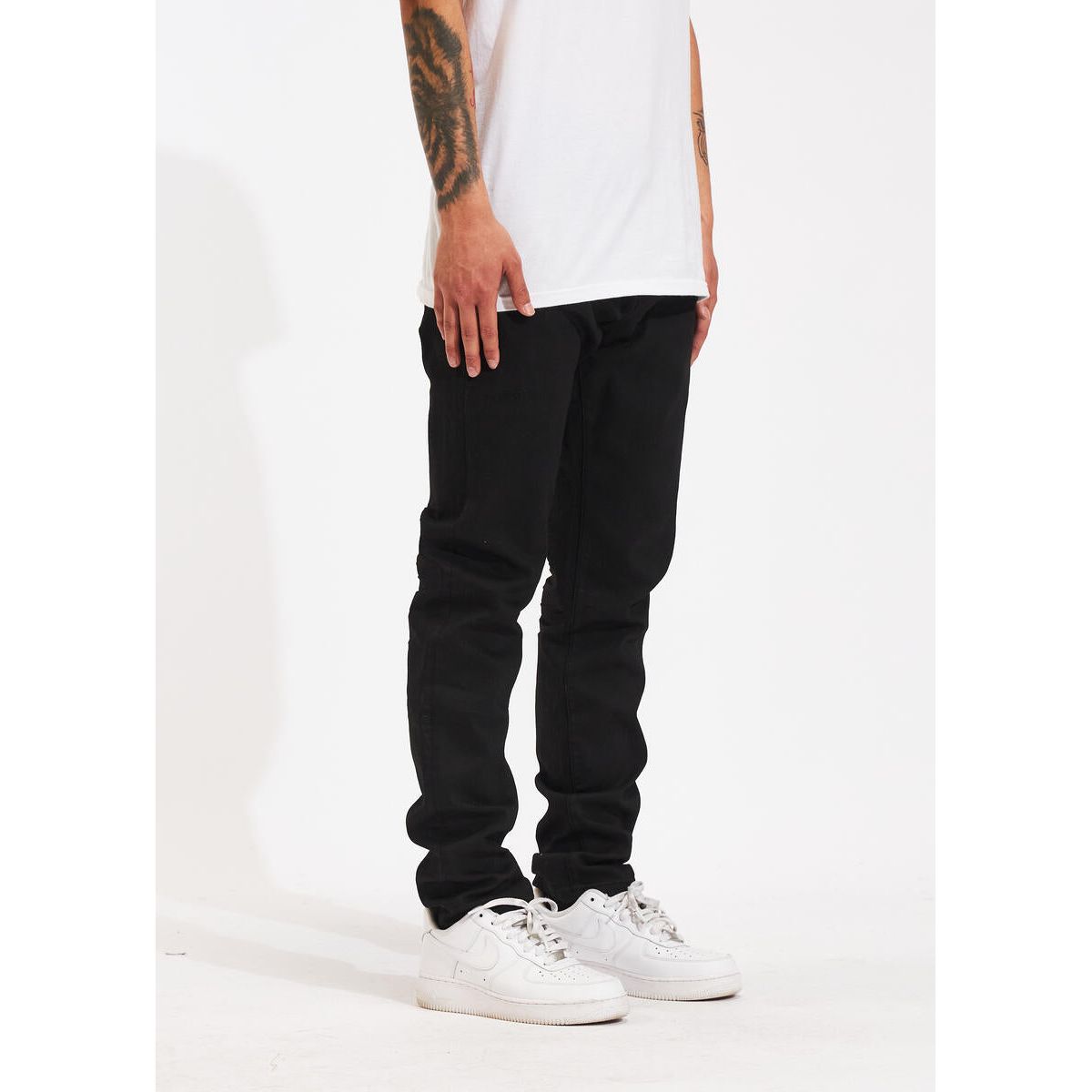 Person holding Crysp Denim Atlantic Regular Black Denim Jeans, emphasizing the quality and durability