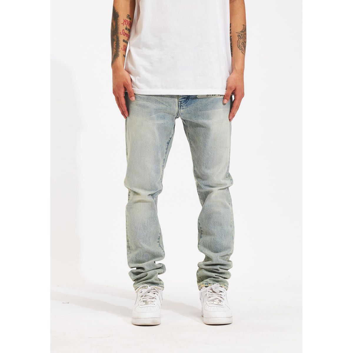 Light wash denim jeans with distressed detailing and a relaxed fit