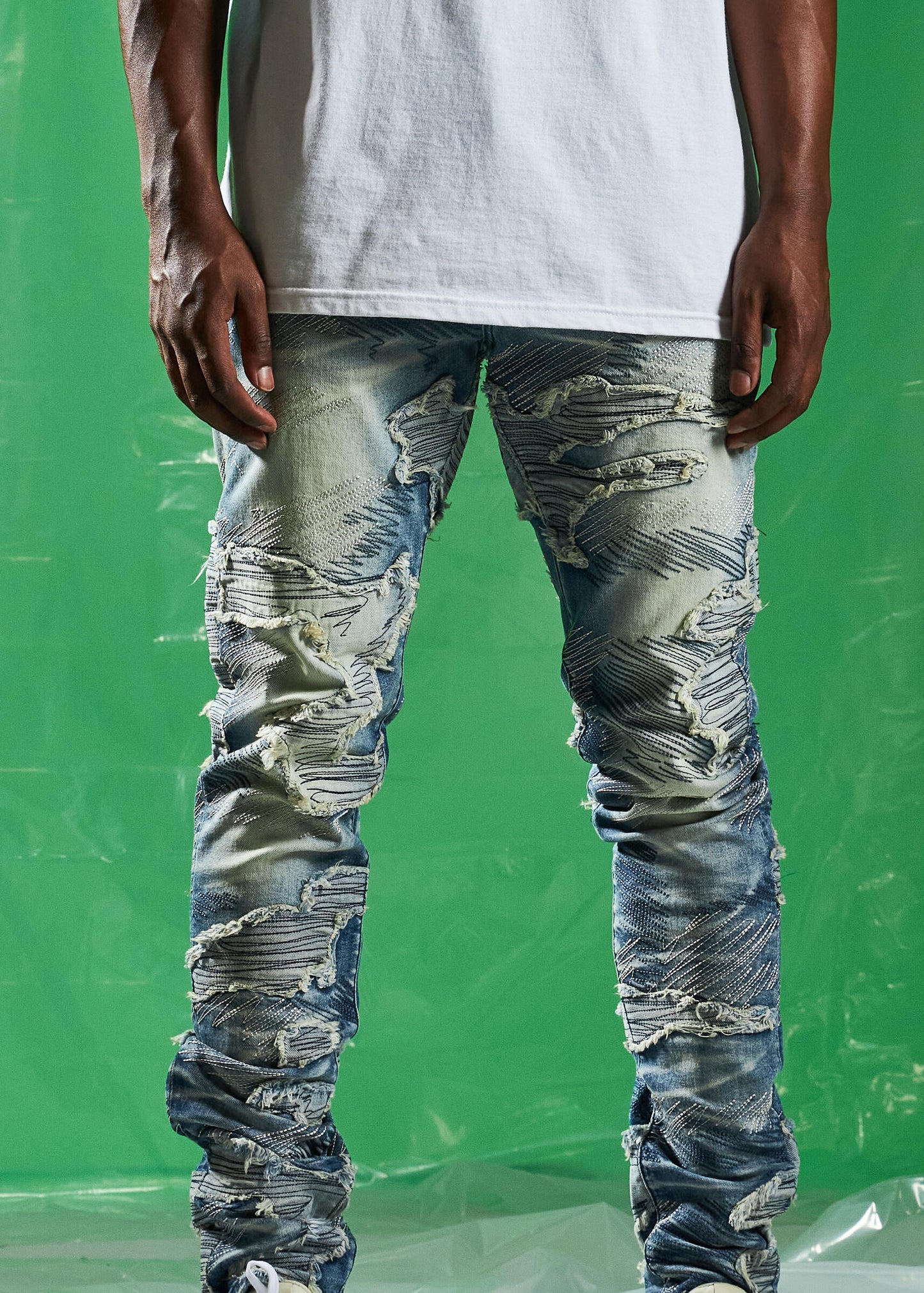 EMBSPR24-016 jeans in mid blue wash with ripped and patched design