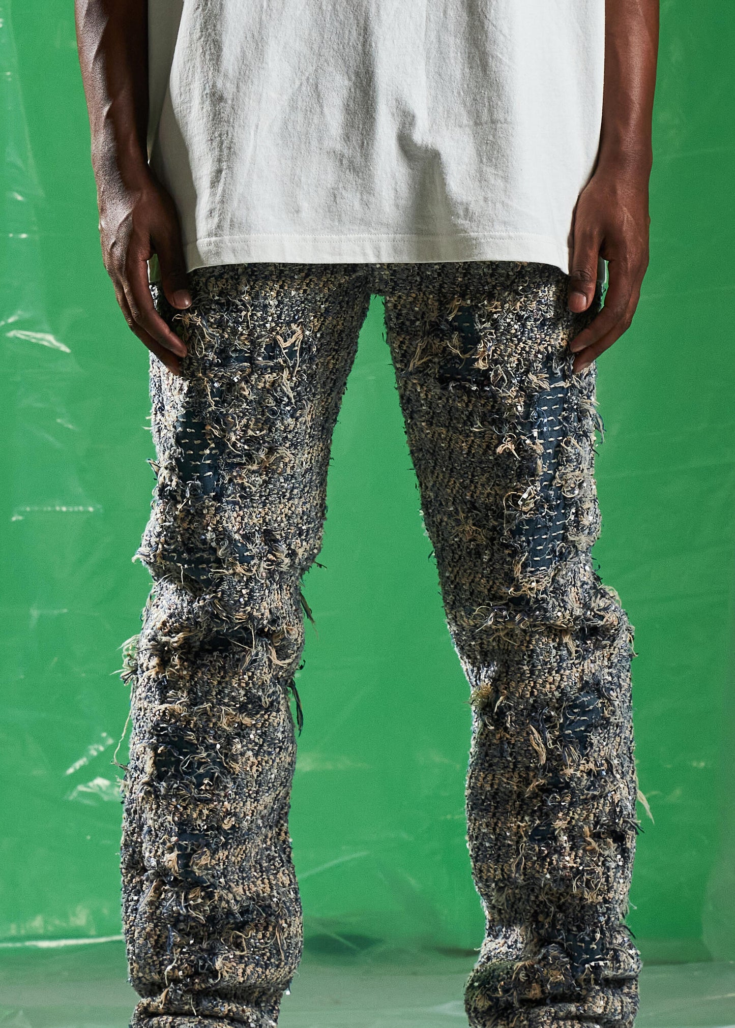 Back view of Embellish Blue Salvage Denim Jeans showcasing embroidered logo and pocket design