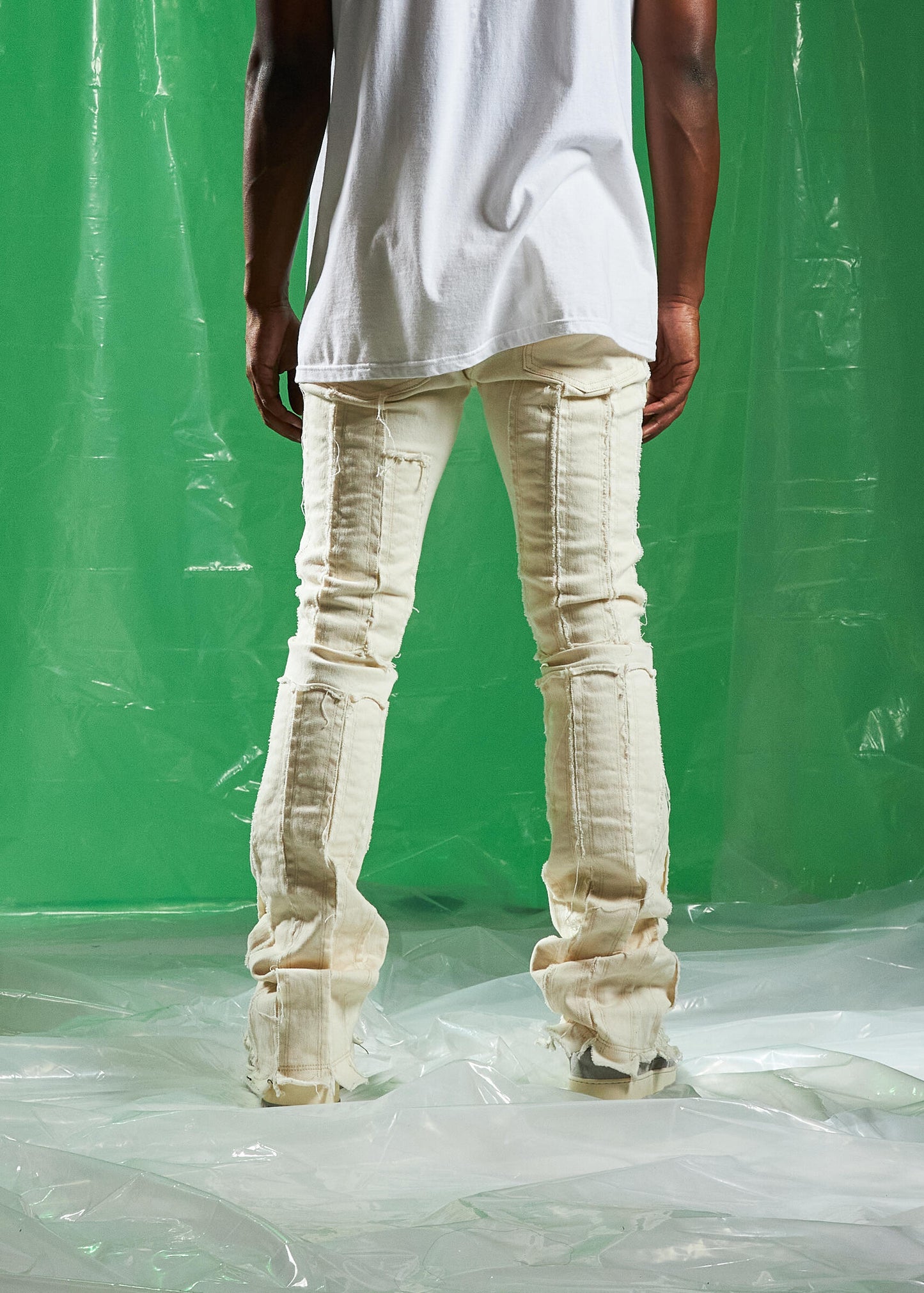 Embellish Ursus Cream Denim Jeans folded on a wooden table