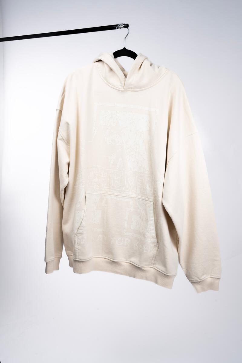 Front view of the Authentics Big A Hoodie in cream, showcasing the soft, plush fabric and the oversized hood, ideal for staying comfortable and stylish on chilly days