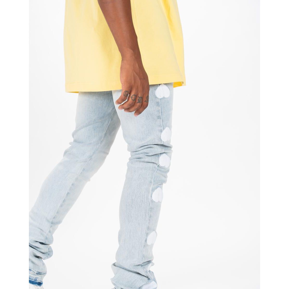 Person wearing PHEELINGS Heartbeat of Success Light Sand Blue Flare Stack Denim standing against a brick wall