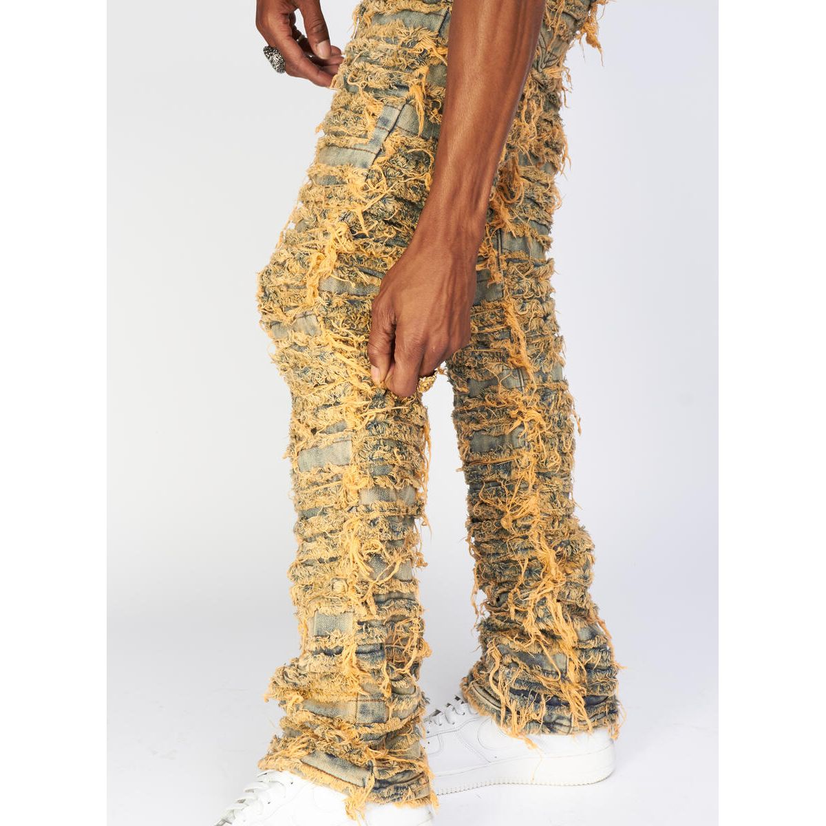 Close-up of distressed denim with frayed hems and unique vintage wash