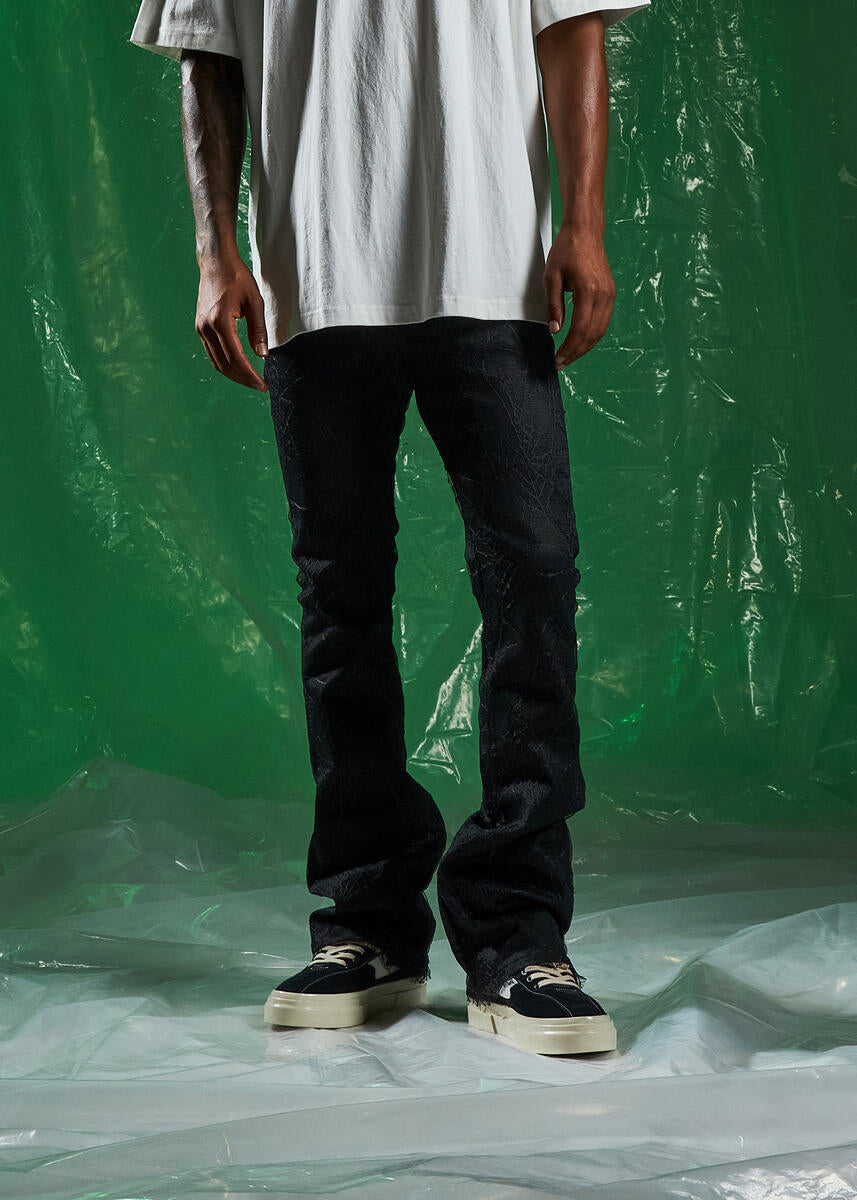 EMBSPR224-043 black denim jeans with spider embellishments and flared legs