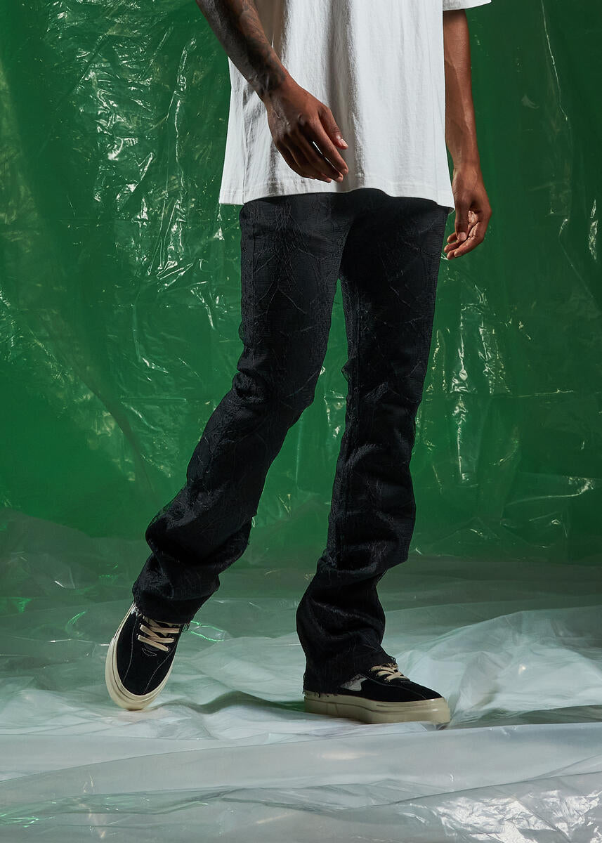 Trendy Black Denim Jeans with Spider Flare Design and Ripped Accents