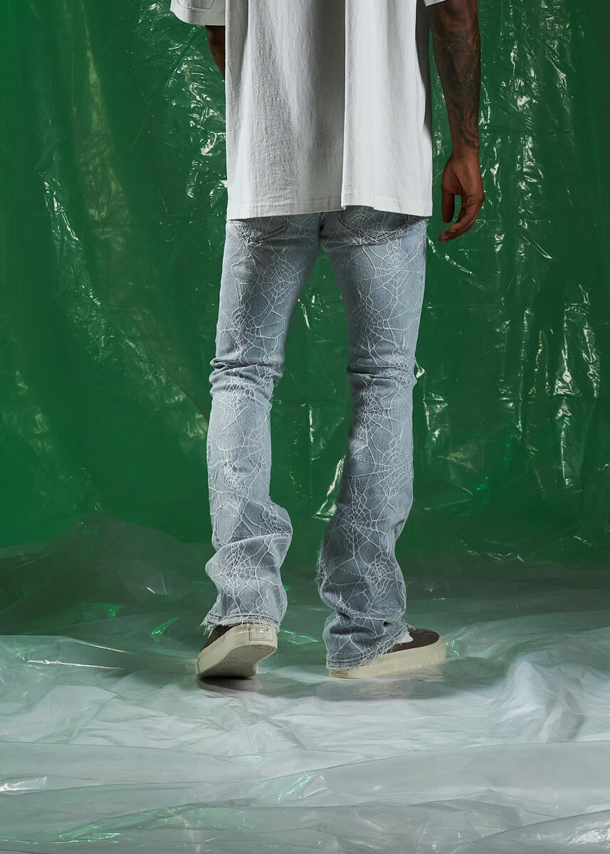 Stylish and trendy light blue denim jeans with spider flare design