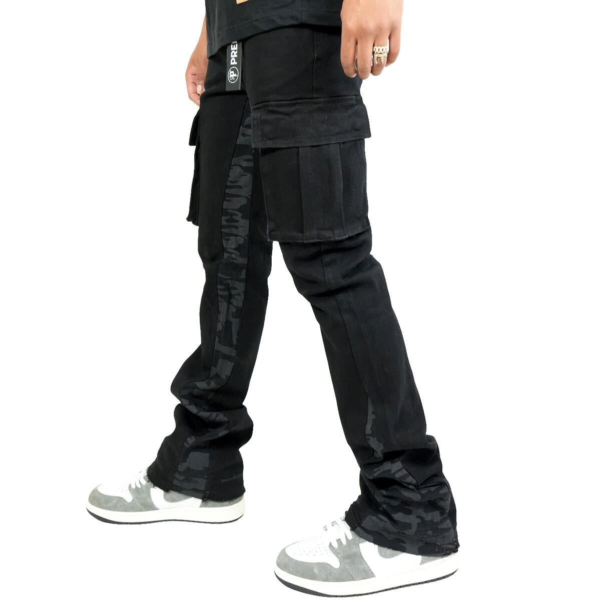 Preme Black Canvas Camo Flare Denim jeans displayed on hanger, highlighting unique camo print and high-quality canvas material
