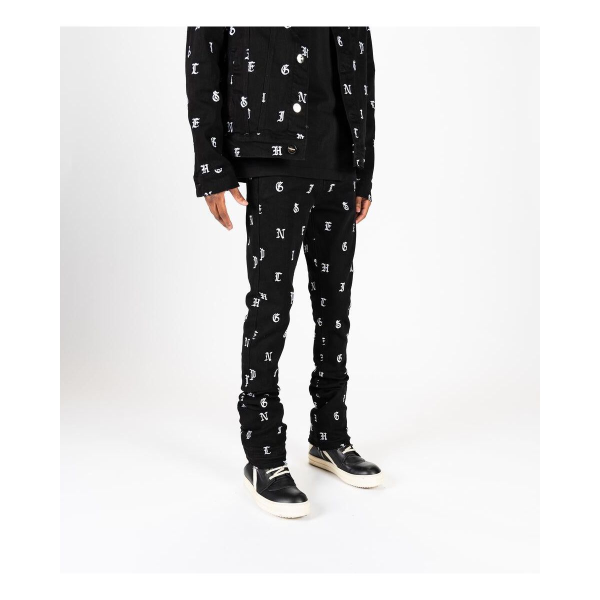 Side view of Soul Stamped denim showcasing the edgy distressed finish and flare stack design