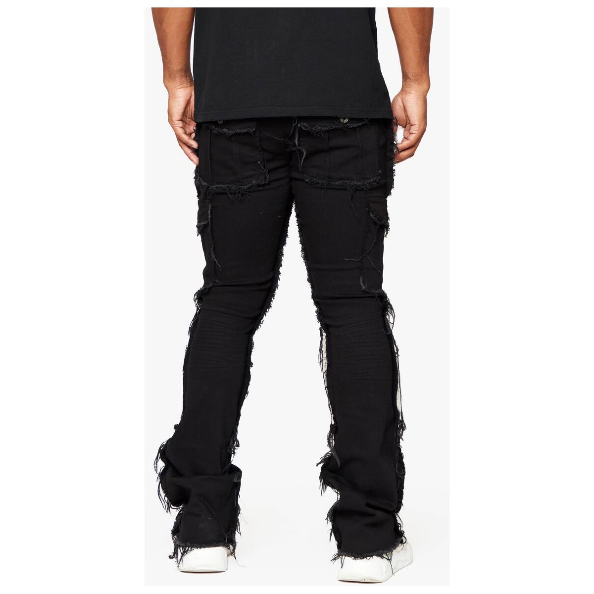 Model wearing Valabasas Aegerine Jet Black Stacked Flare Denim with a white graphic t-shirt and sneakers