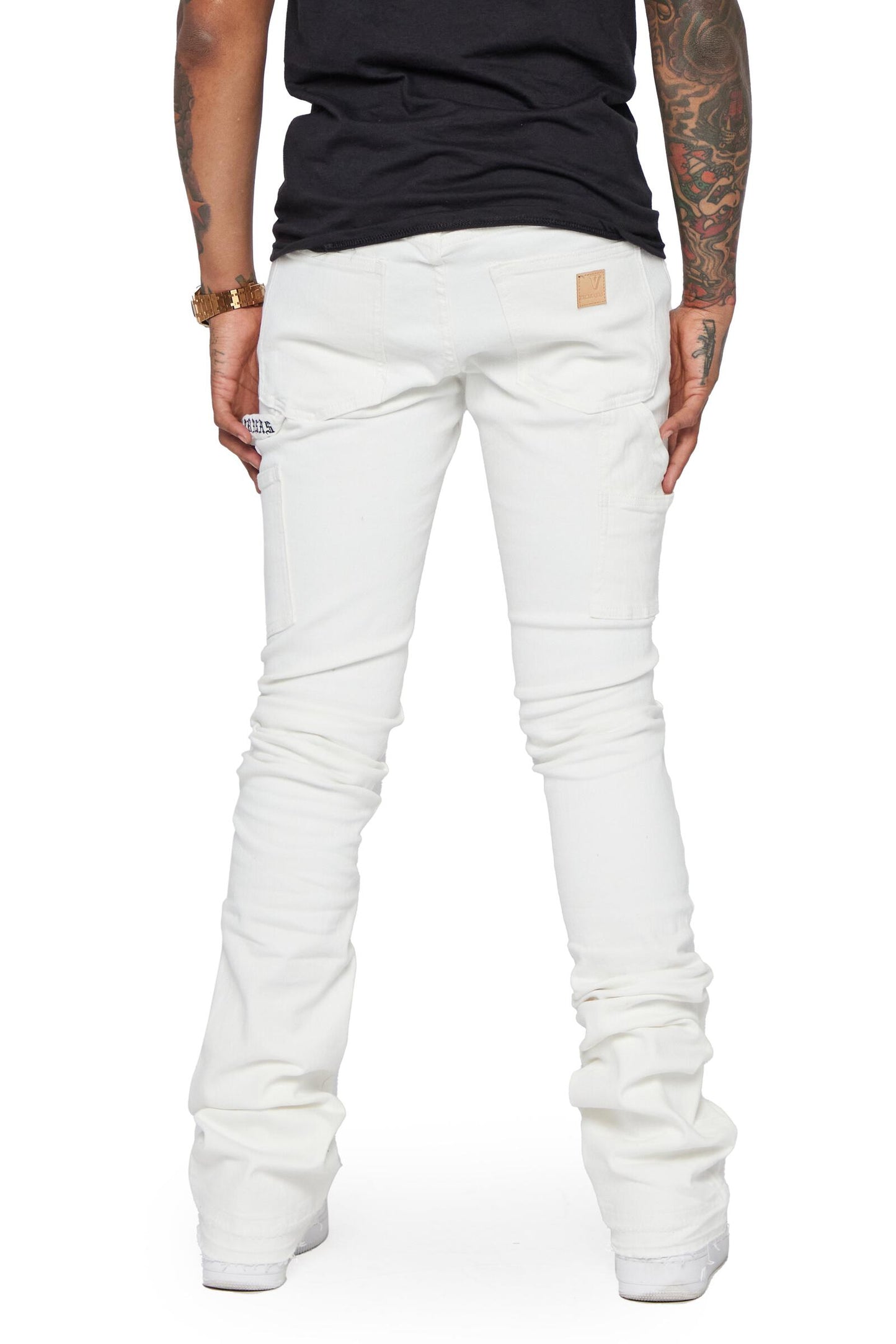Valabasas Mr Extendo White Super Stacked Flare Denim Jeans on model with high-waisted fit, distressed details, and wide leg opening