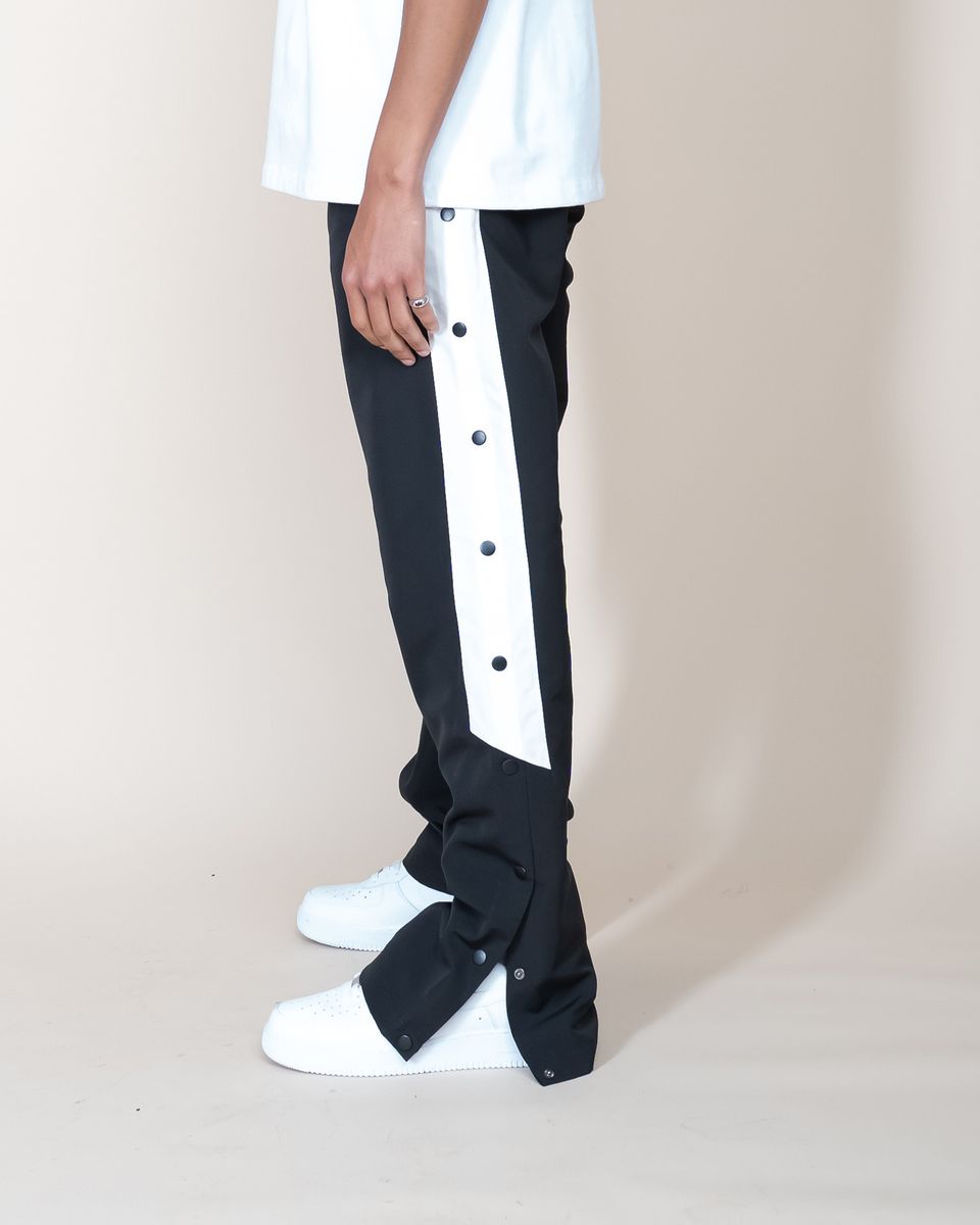 Close-up of EPTM Goat Flared Pants in Black fabric texture