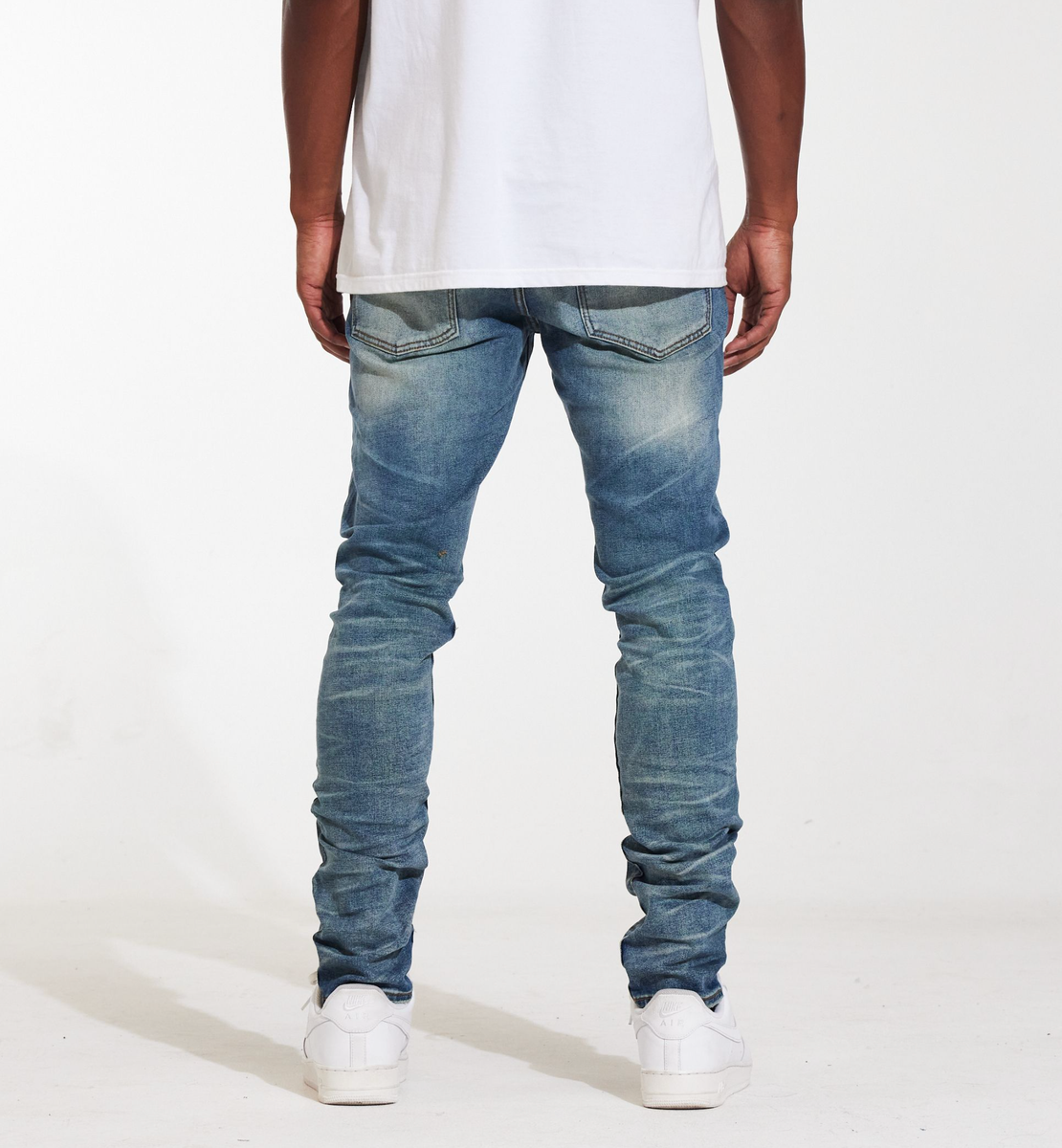 Person wearing the Crysp Denim Atlantic Medium Wash Denim Jeans (CRYSPSUM24-027) to show fit and style