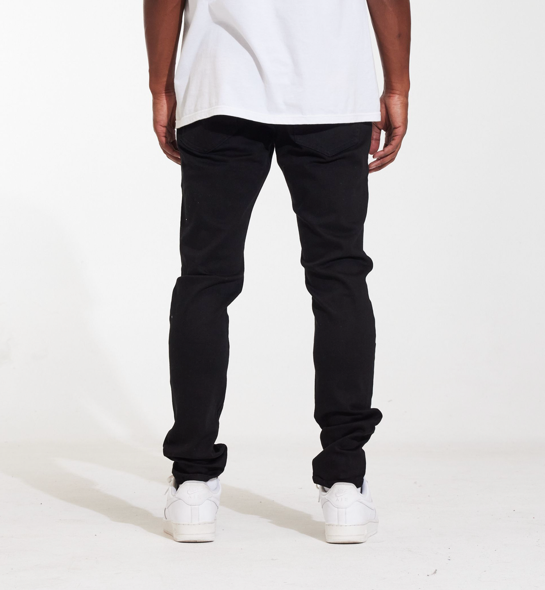 Back view of the Crysp Denim Atlantic Black Ripped Denim Jeans, showing the back pockets and distressed detailing