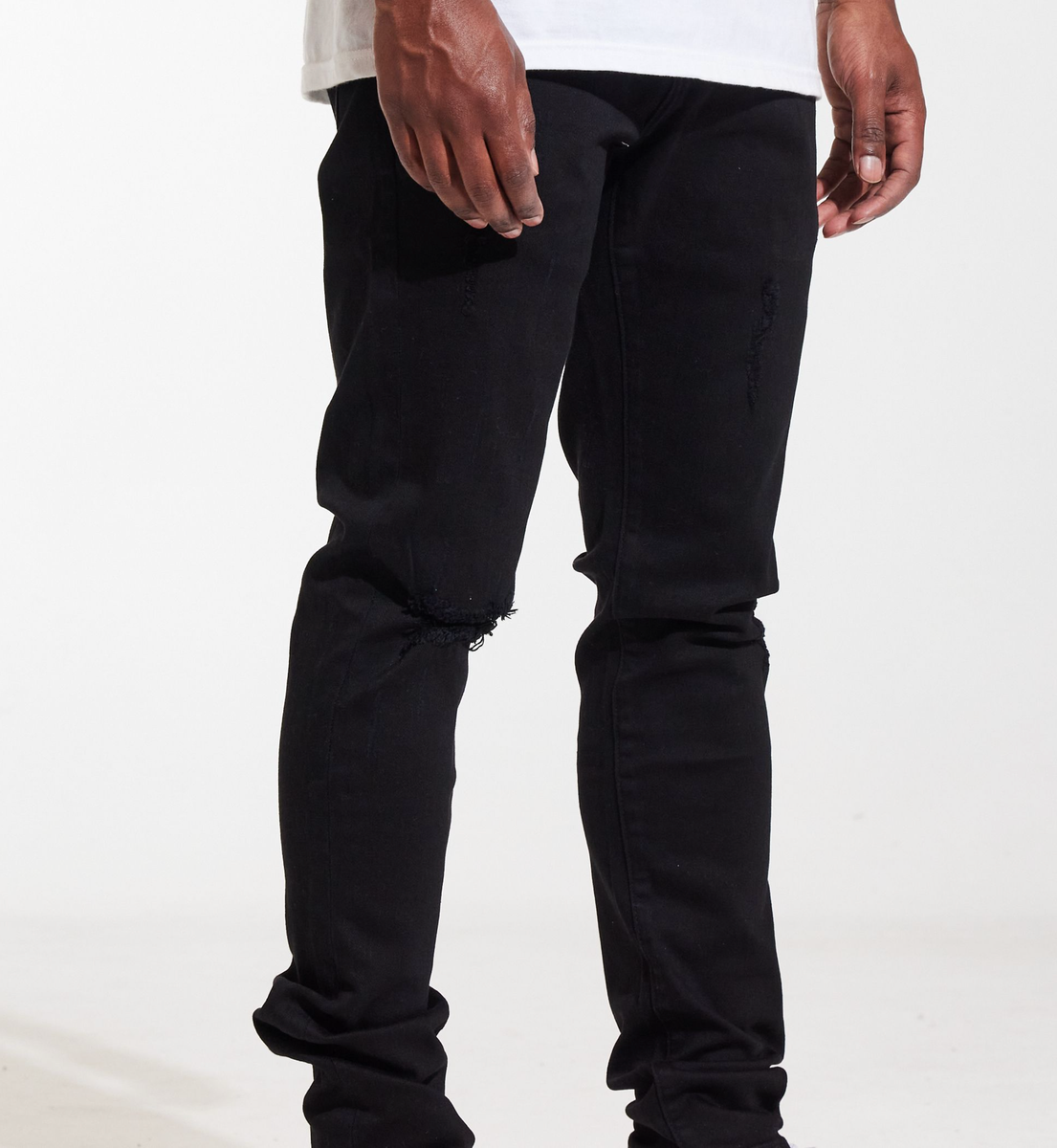 Side view of the Crysp Denim Atlantic Black Ripped Denim Jeans, highlighting the slim fit and frayed hem