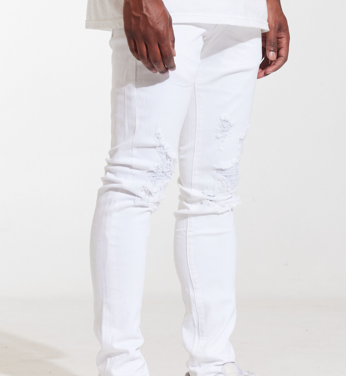Close-up image of Crysp Denim Atlantic White Ripped Denim Jeans, a fashion-forward and distressed pair of jeans with a stylish and unique design (CRYSPSUM24-037)
