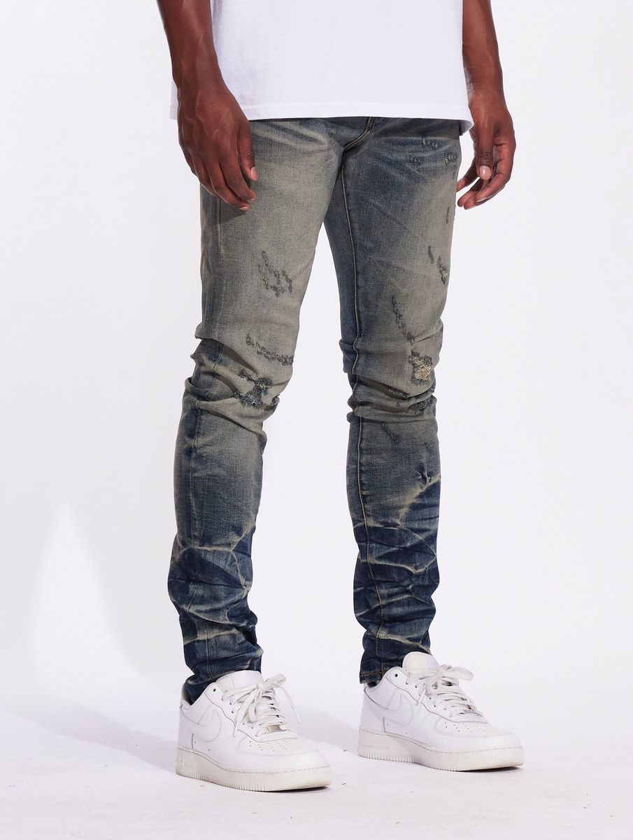 Crysp Denim Atlantic Dusty Indigo Denim Jeans (CRYF24-117) displayed with a stylish belt and paired with casual sneakers for a trendy look
