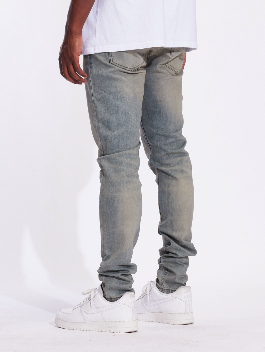 Close-up of the Crysp Denim Atlantic Pacific Wash Denim Jeans (CRYF24-127) featuring distressed detailing and a slim fit design