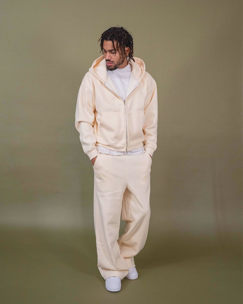 Cream fleece pants featuring waist pockets and back pocket