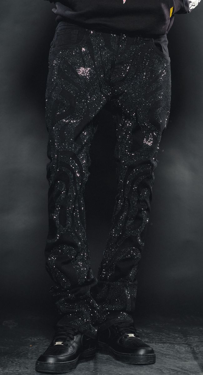Black denim jeans with a stylish and edgy rhinestone design