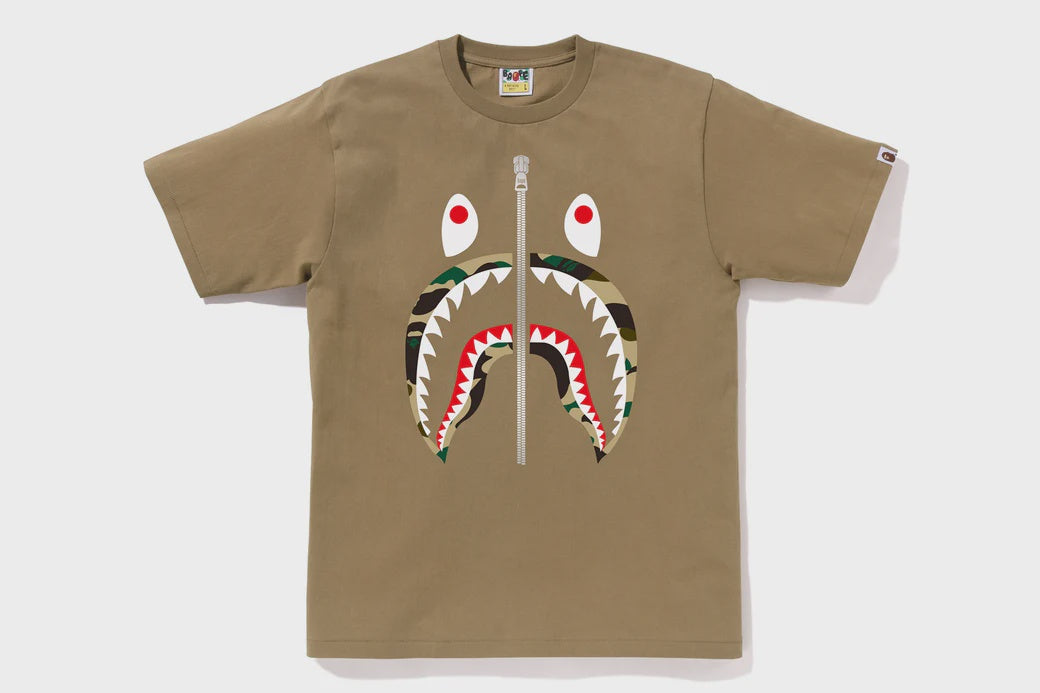 BAPE 1st Camo Shark Tee in beige, featuring iconic shark design and unique camouflage pattern