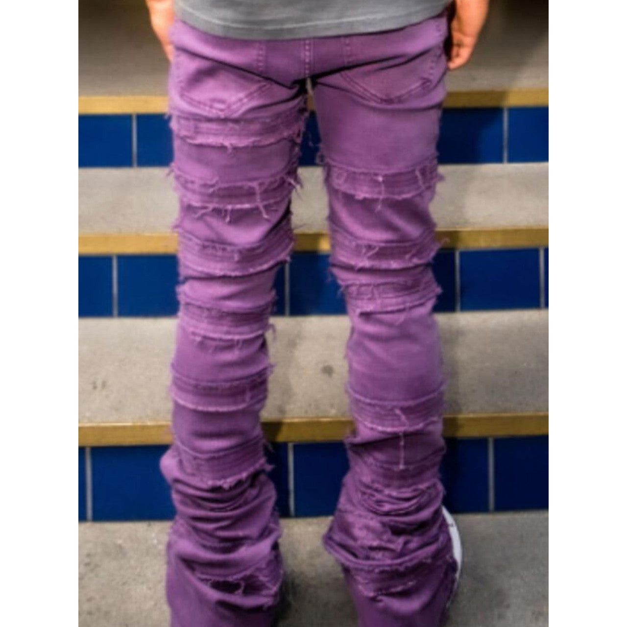 Back view of the jeans featuring stacked design and unique purple wash