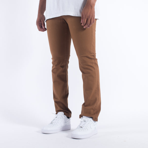 Side view of BLKWD The Linden Standard Tobacco Jeans featuring a slim fit, button fly, and high-quality tobacco-colored denim fabric