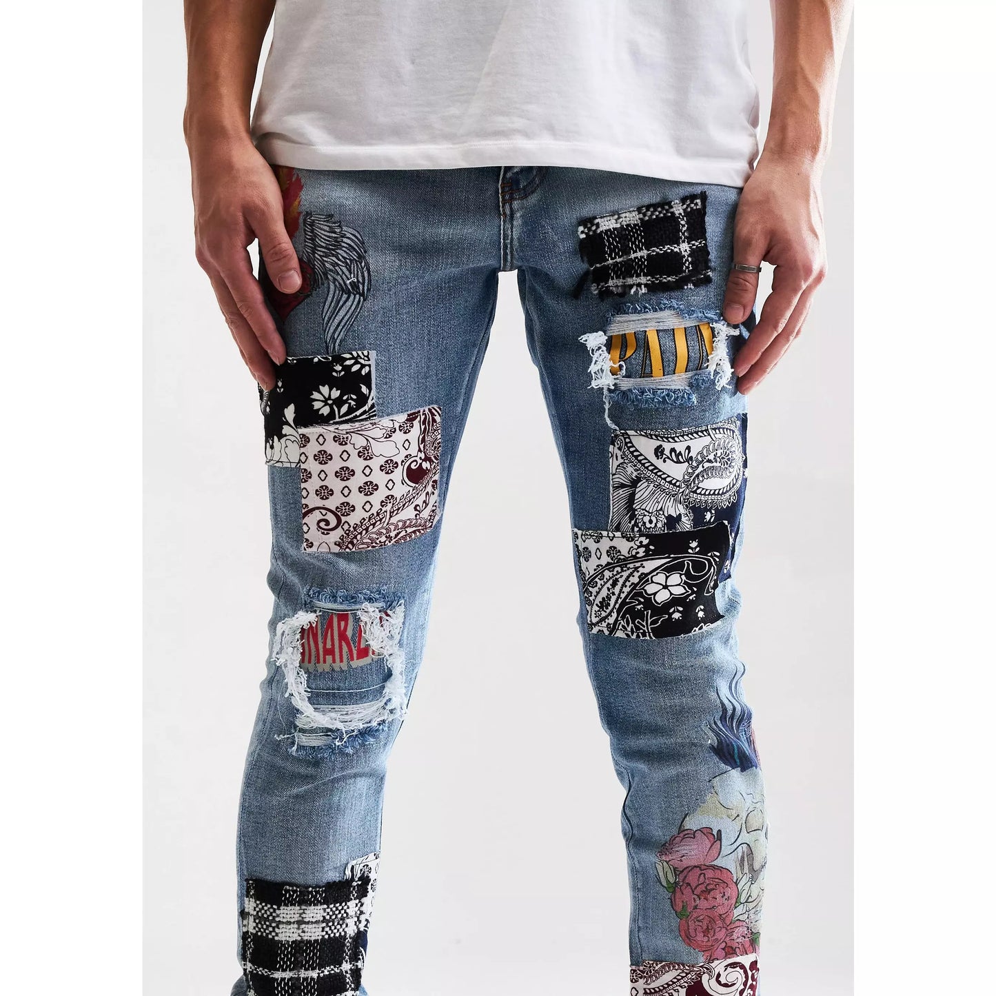 Embellish Arcadia Blue Patchwork Denim Jeans displayed on a hanger