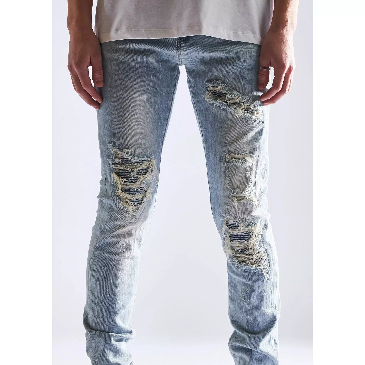 EMBHOL21-1-8 jeans with rip and repair design, light blue wash, and slim fit