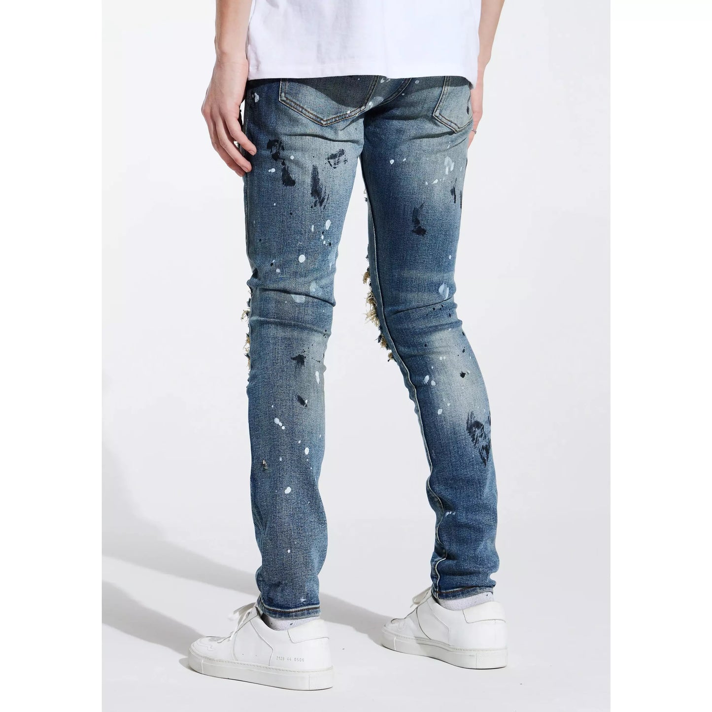 Close-up of Embellish Tyson Rip & Repair Denim showing intricate rip and repair design with frayed edges
