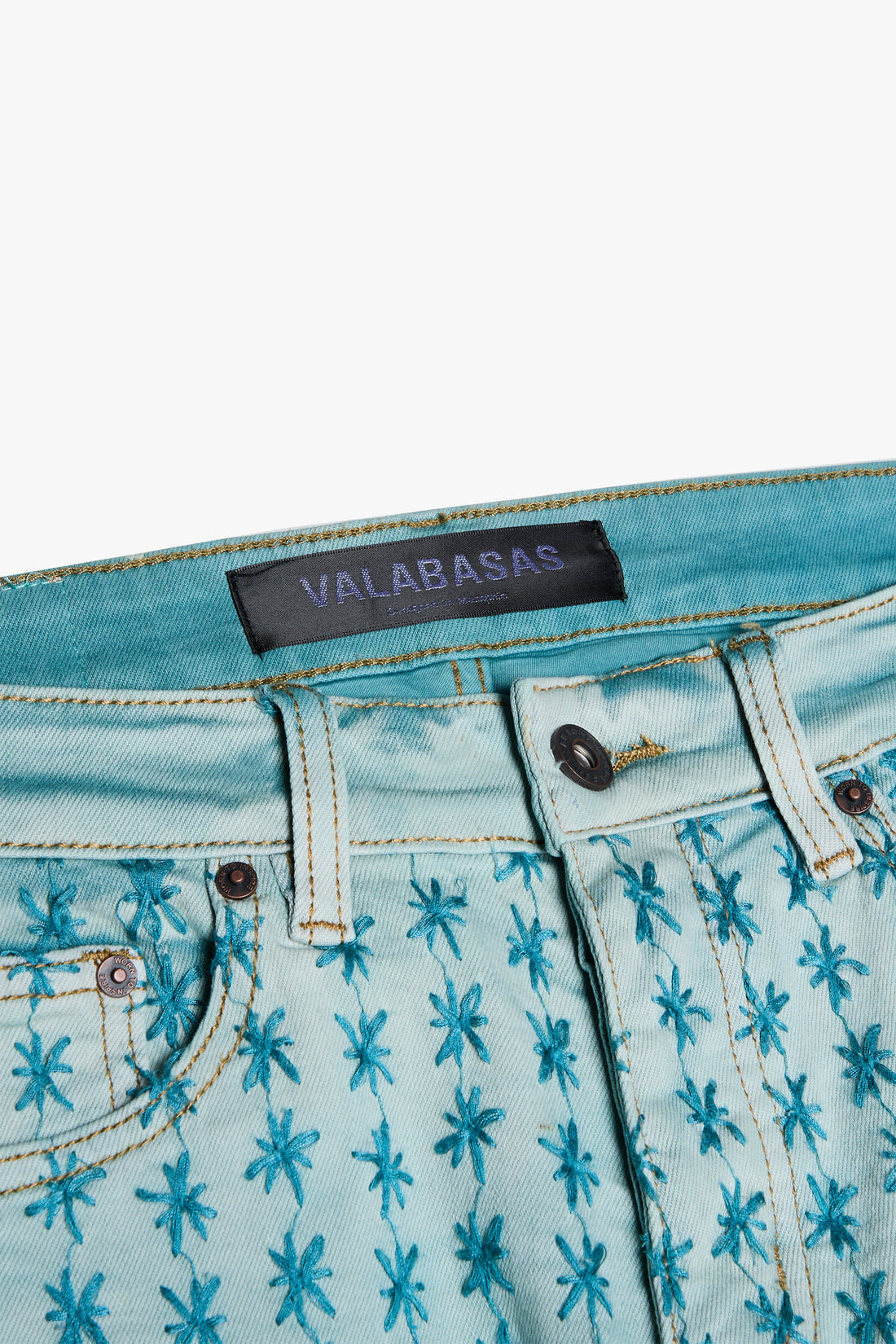 Valabasas Asterisk Light Blue/Blue Stacked Flare Jeans styled with white sneakers and a crop top