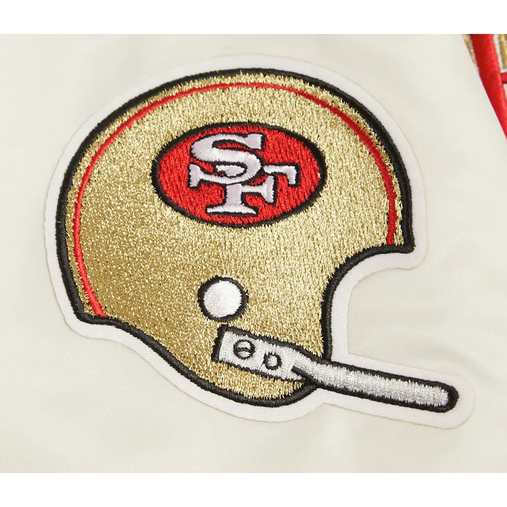 Model wearing the Pro Standard San Francisco 49ers Retro Classic Rib Satin Jacket - Eggshell/Red (FS4643597-ERD) to show fit and style