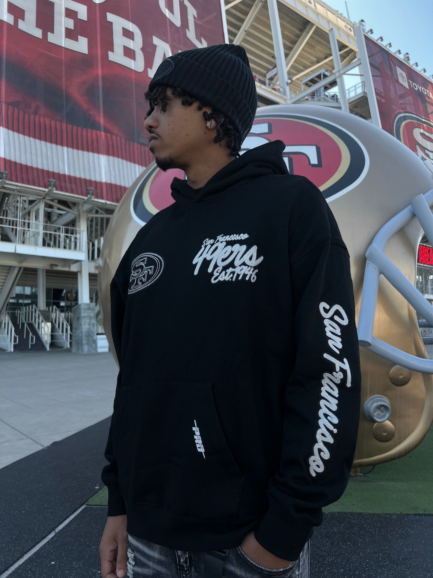 High-quality Pro Standard San Francisco 49ers Drop Shoulder Hoodie in Black, side view, showcasing team logo and comfortable fit