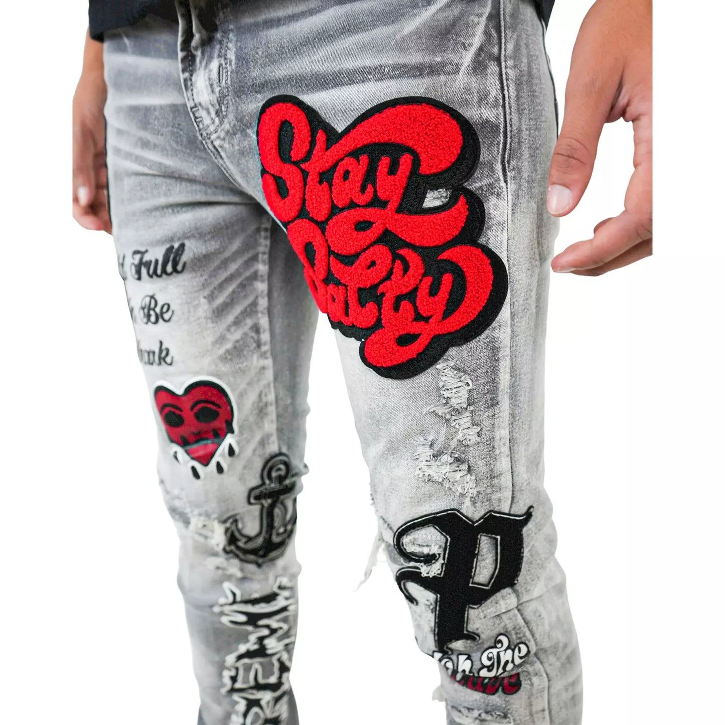 Side view of PREME Grey Wash Patches Ripped Denim Jeans showcasing the ripped patches