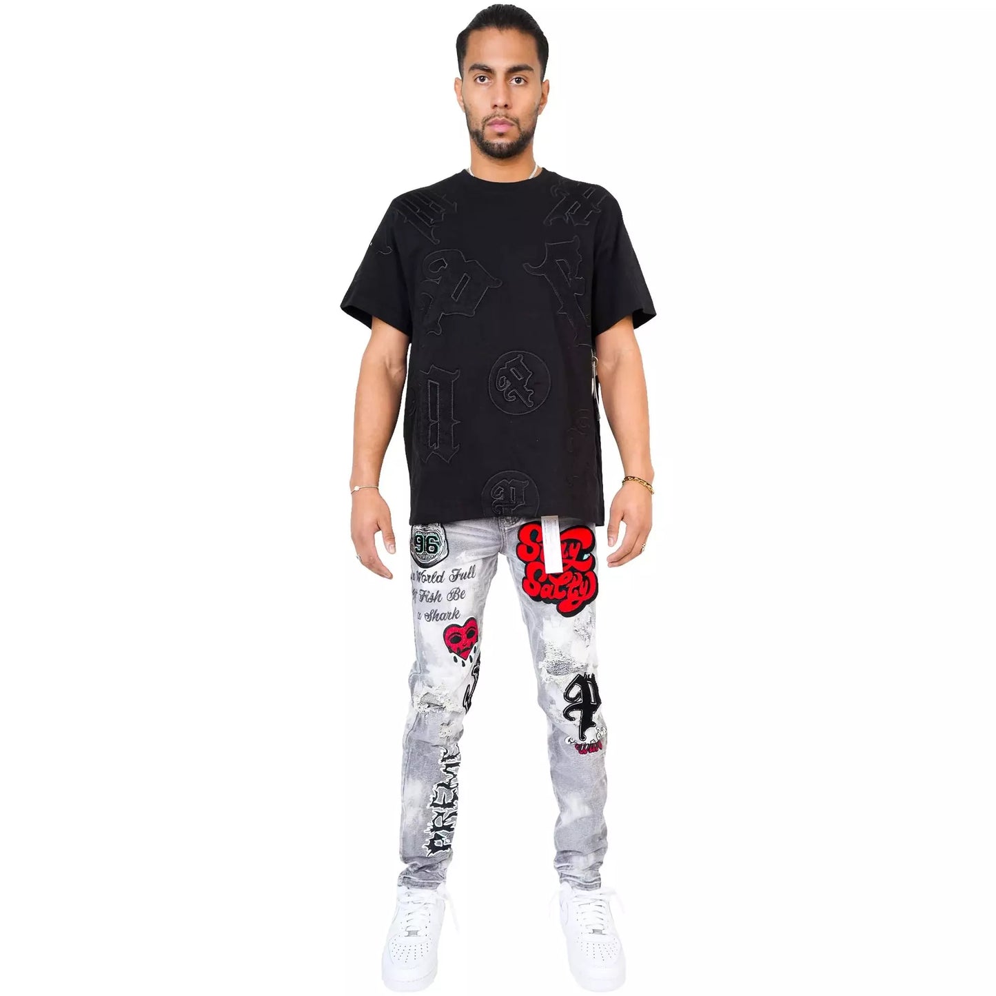 PREME Grey Wash Patches Ripped Denim Jeans folded to display the wash and distressing