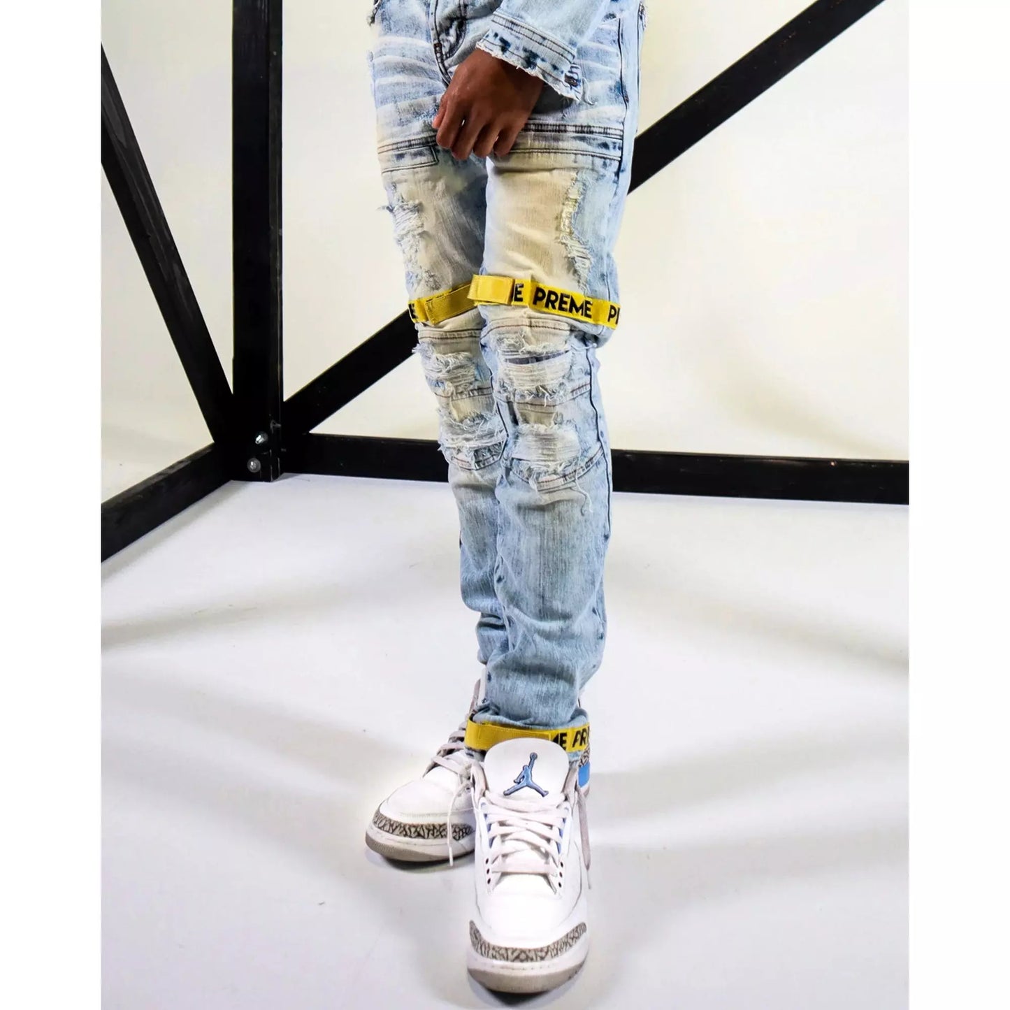 Preme Yellow Strap Desert Indigo Denim Jeans (PR-WB-843) displayed on mannequin in front of desert backdrop with yellow straps and stylish design