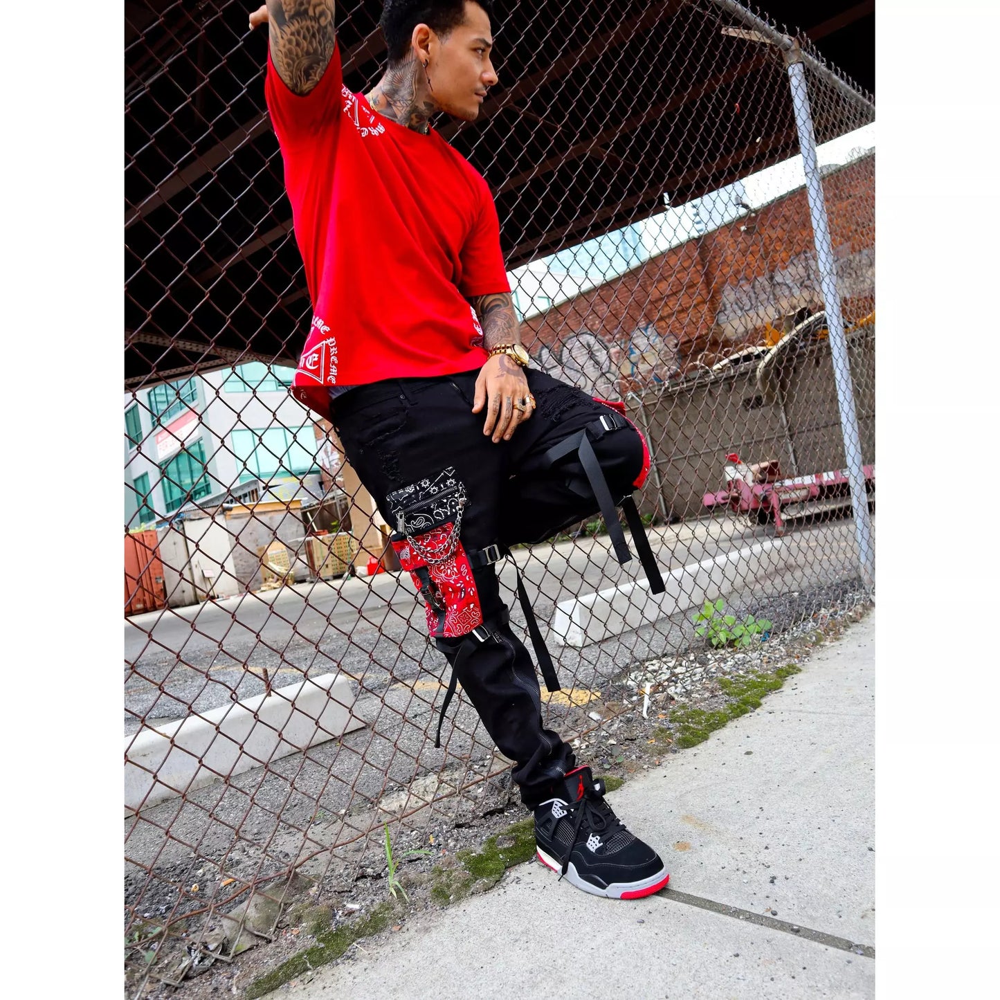 Black denim jeans with paisley patches and distressed details for men