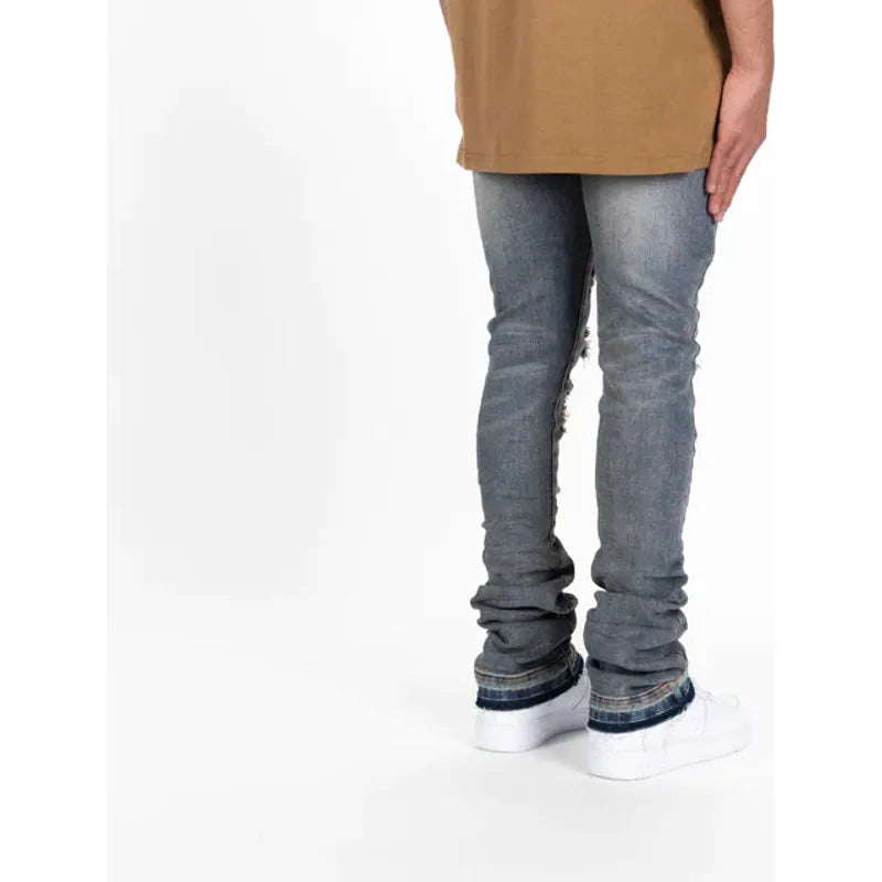 Close-up of PHEELINGS Now Or Never Medium Rust Blue Flare Stack Denim, showcasing distressed denim with a unique rust blue flare design