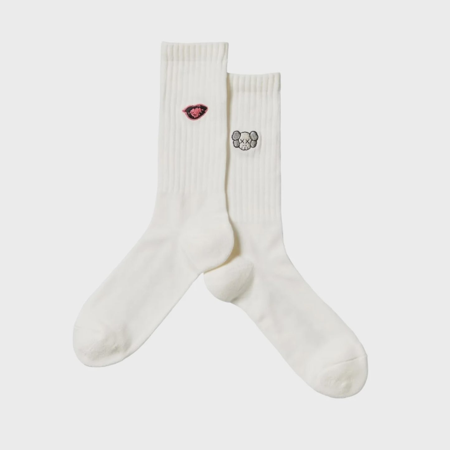 White socks featuring KAWS and Warhol collaborative artwork design, stylish and collectible
