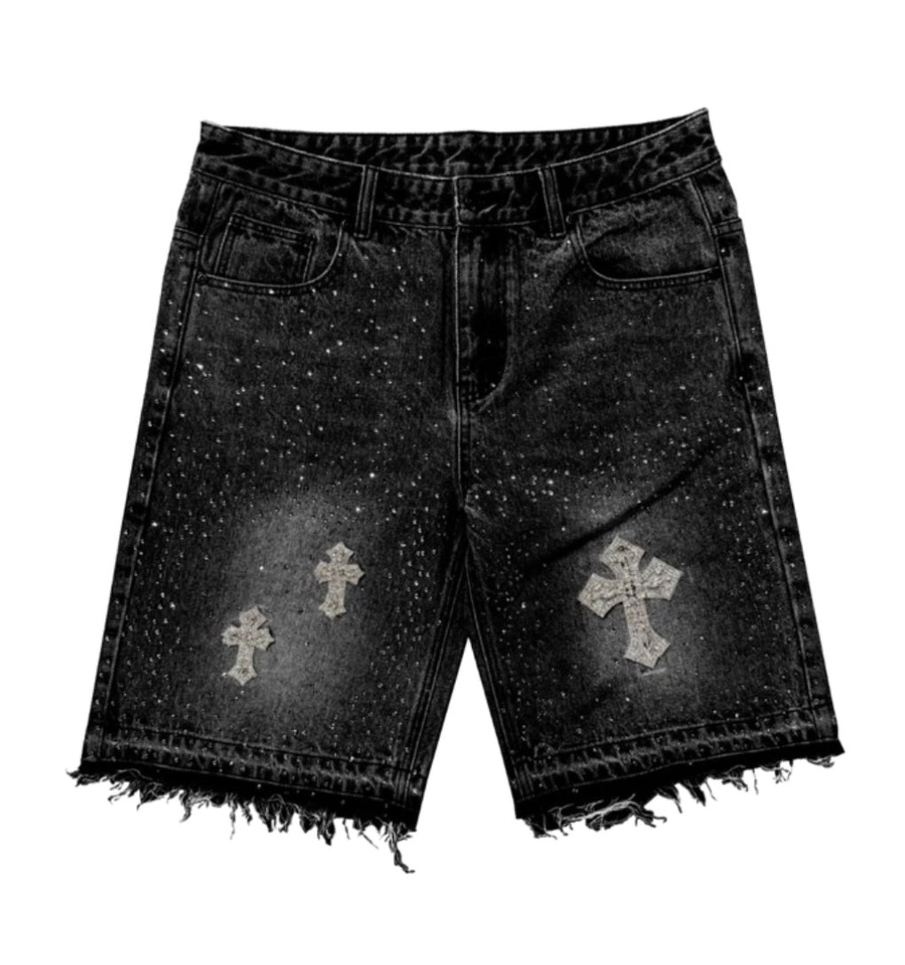 A close-up view of black denim shorts featuring raw edges and embellished details for a stylish, edgy look