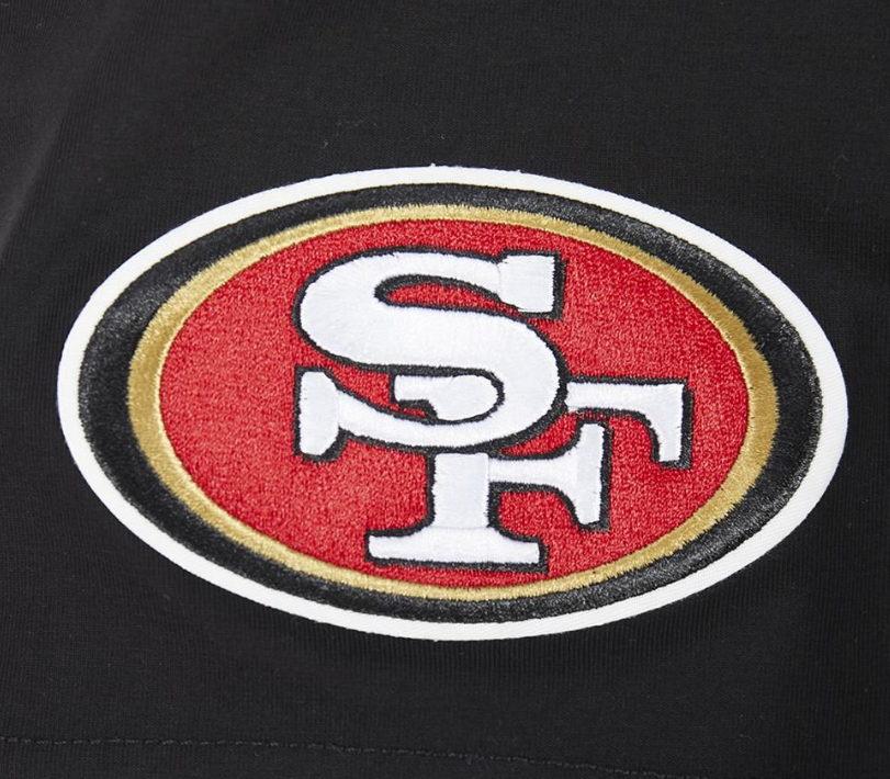 Full-length image of a model wearing the black San Francisco 49ers City Ransom Tee showcasing casual style