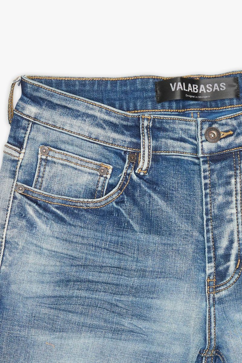 Close up of Valabasas Mr Stacked Medium Washed Stacked Denim Jeans back pockets with logo embroidery