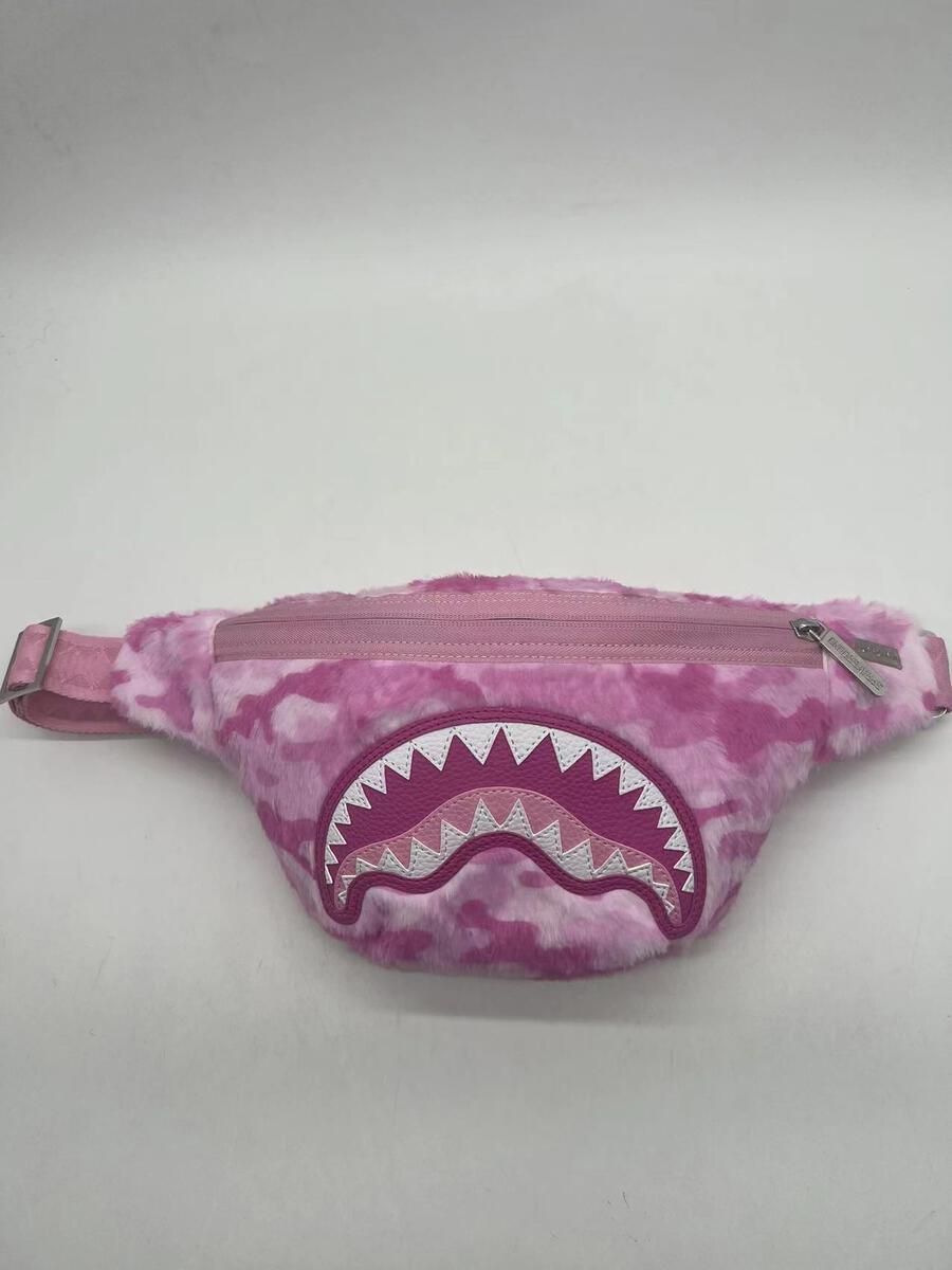 A stylish pink camouflage faux fur Sprayground Savvy Crossbody bag with a sleek design