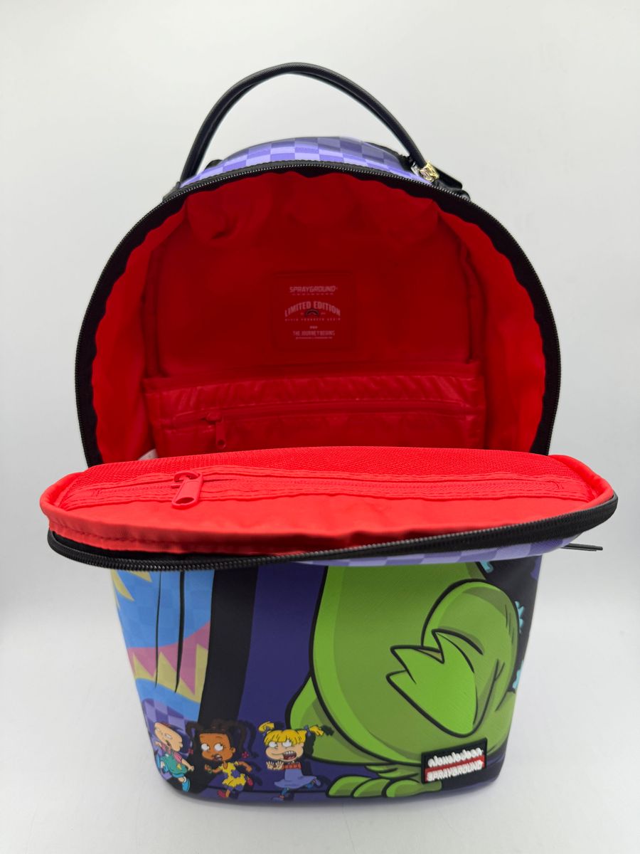 Side profile of the Sprayground Reptar Chase Backpack highlighting its durable construction and spacious interior dimensions
